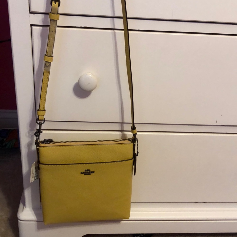 Never been worn Coach side purse with purchase tag